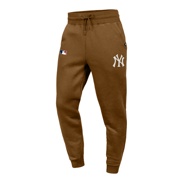 The model is wearing these MLB New York Yankees ’47 Islington Track Pants in dark brown. 1