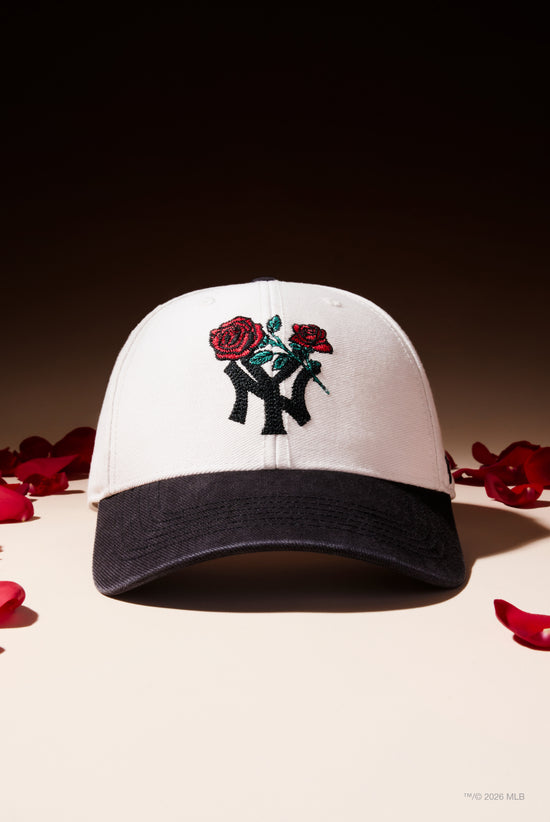 Slide 5:Black and White cap with roses motif on the front of a New York Yankees logo