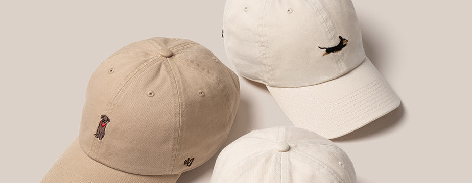 Three '47 hats in beige with dogs embroidered.
