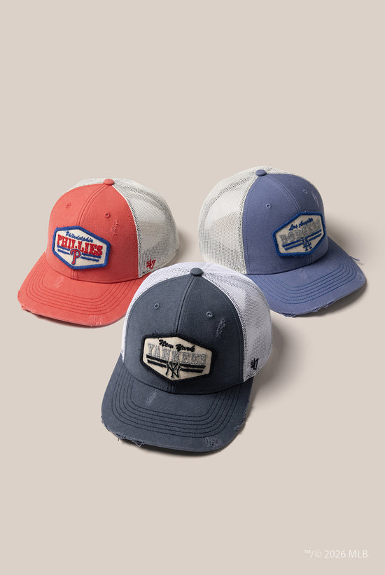 Slide 3:Three mesh baseball caps with different colour combinations and logos on a beige background
