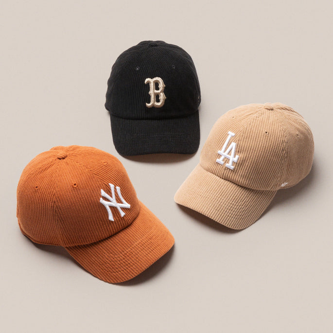 A black Boston Red Sox hat, brown Los Angeles Dodgers hat and orange New York Yankees hat all in corduroy material